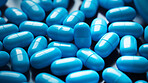 Blue pills background. Health supplement and science medicine research concept