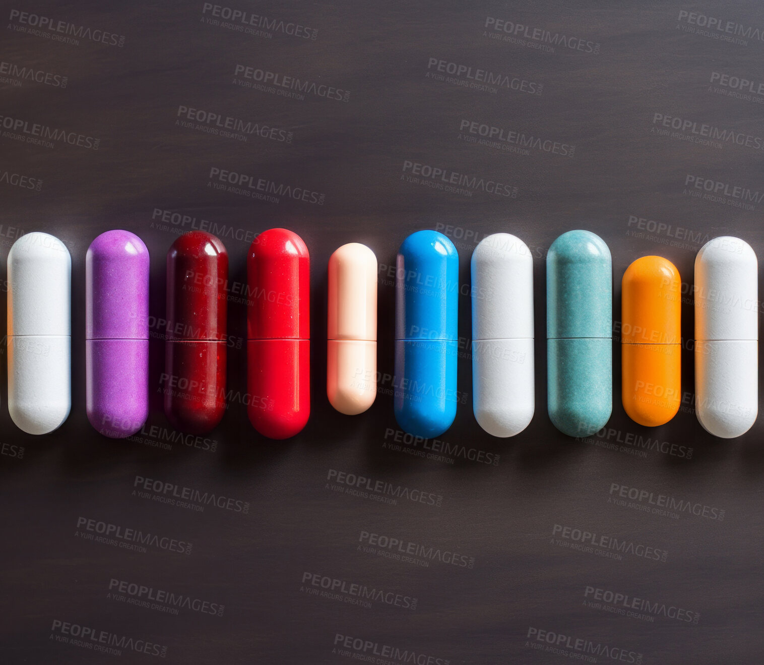 Buy stock photo Colorful pills in line on table. Health supplement and science medicine research concept