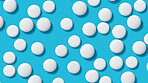 White pills on blue background. Health supplement and science medicine research concept