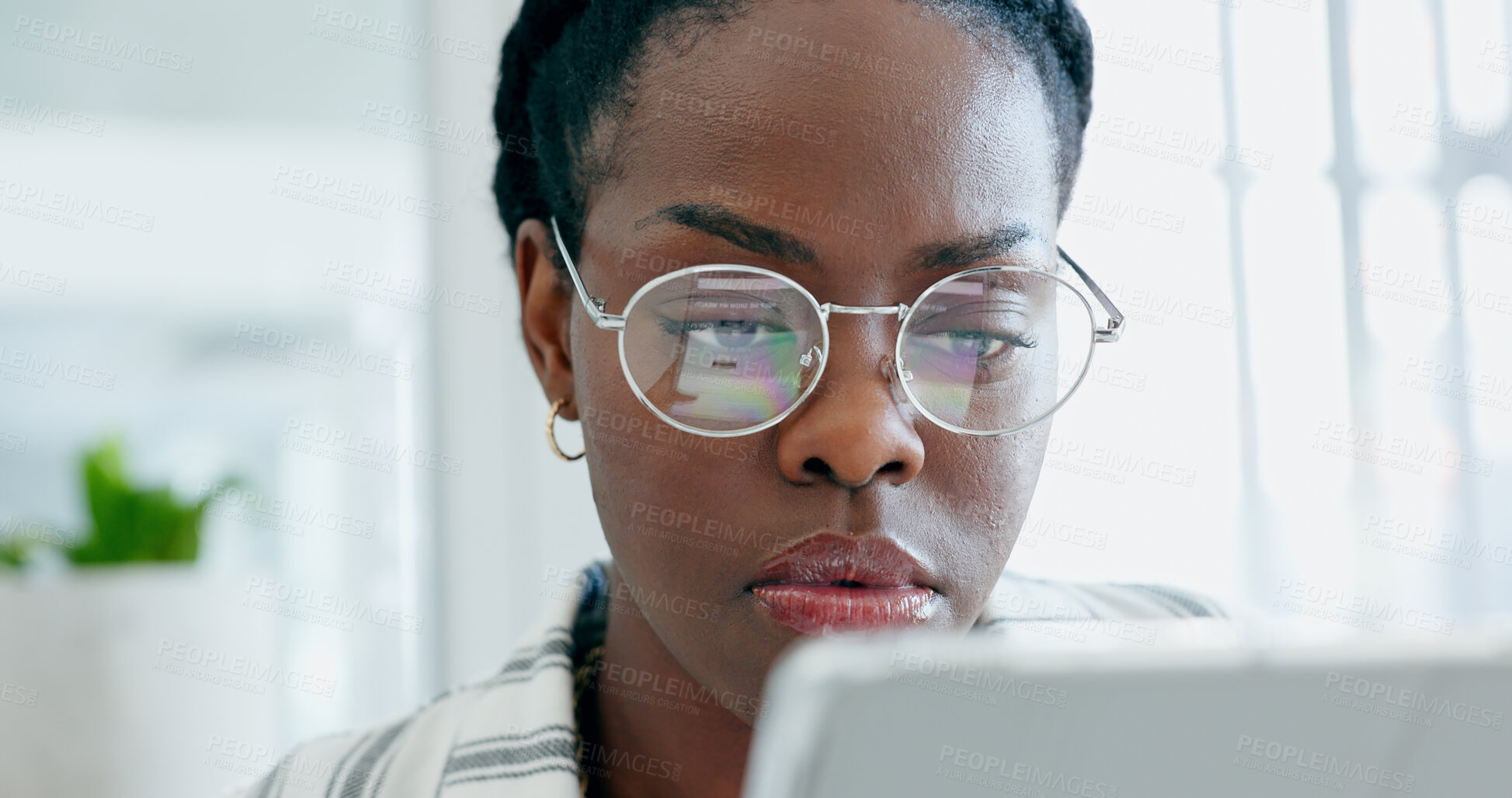 Buy stock photo Serious black woman, business and research on tablet, reading email on app and planning in creative startup office. Digital technology, professional and African designer working on internet project