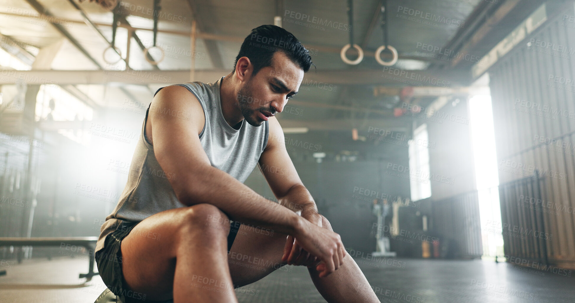 Buy stock photo Fitness, breathing and sweating with a tired man in the gym, resting after an intense workout. Exercise, health and fatigue with a young athlete in recovery from training for sports or wellness