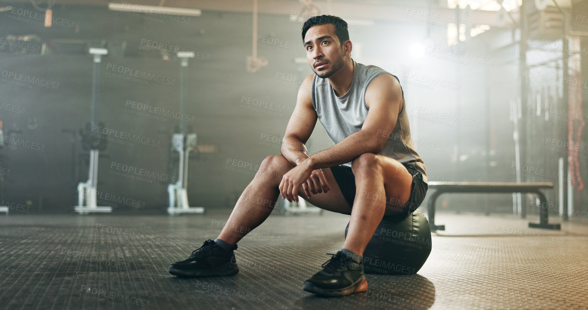 Buy stock photo Fitness, breathing and sweating with a tired man in the gym, resting after an intense workout. Exercise, health and fatigue with a young athlete in recovery from training for sports or wellness