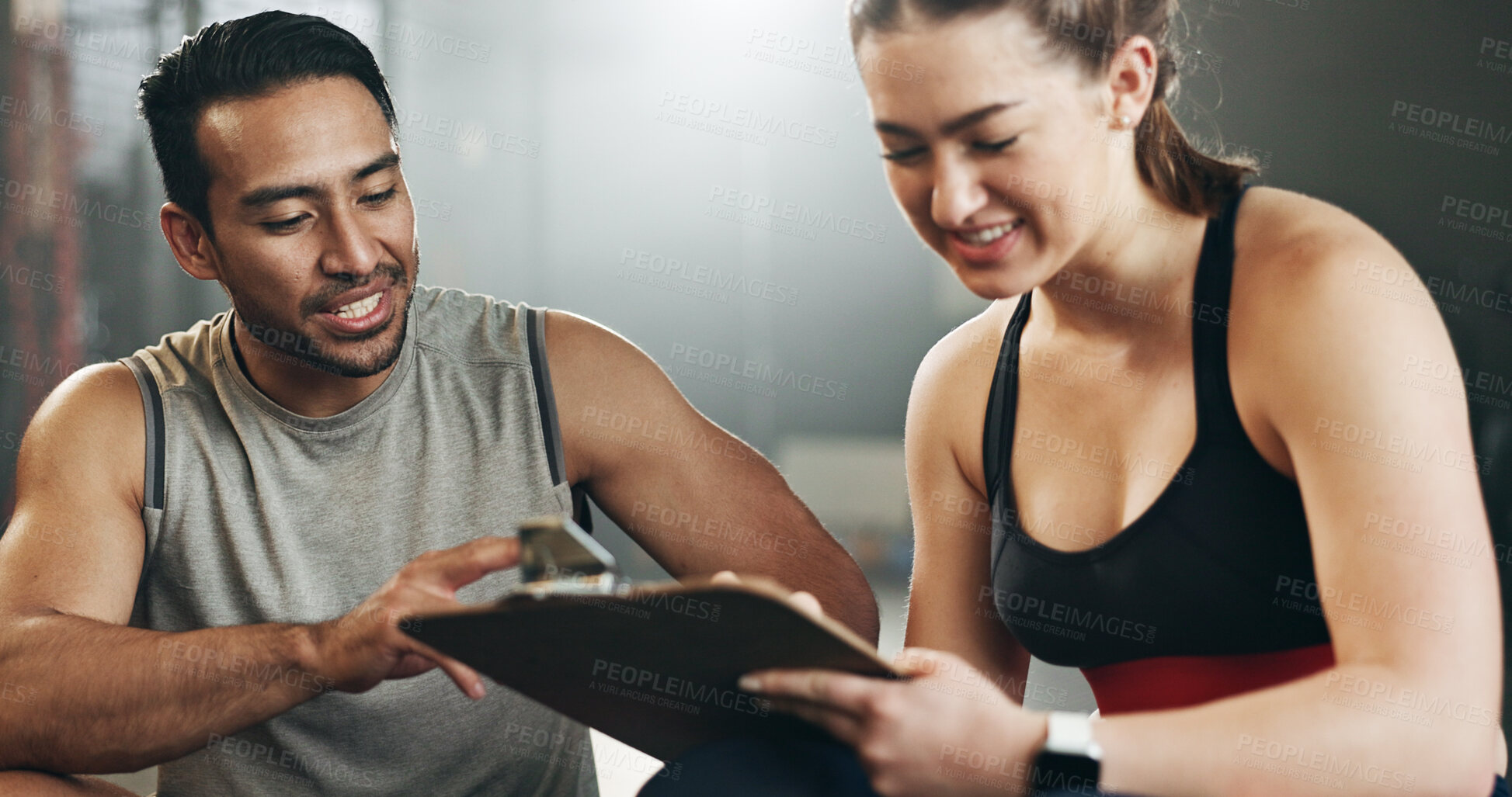 Buy stock photo Man, woman and clipboard with writing in gym, sign up and planning for ideas, workout and smile with info. Personal trainer, paperwork and signature for fitness, checklist or agreement for wellness