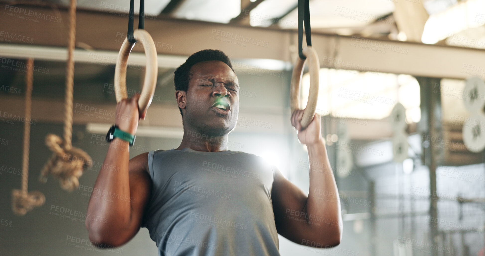 Buy stock photo Sports, gymnastics and black man doing pull up exercise for arm muscle training or workout in gym. Fitness, bodybuilding and African male athlete doing an intense strength challenge in health center.