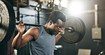 Black man at gym, weight lifting and barbell for muscle building endurance, strong body or balance power in fitness. Commitment, motivation and bodybuilder in workout challenge in health and wellness