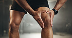 Fitness, knee pain and hands of man at gym for training with muscle, problem or arthritis. Sports, injury and leg of male athlete with joint massage for fibromyalgia, osteoporosis or bone accident