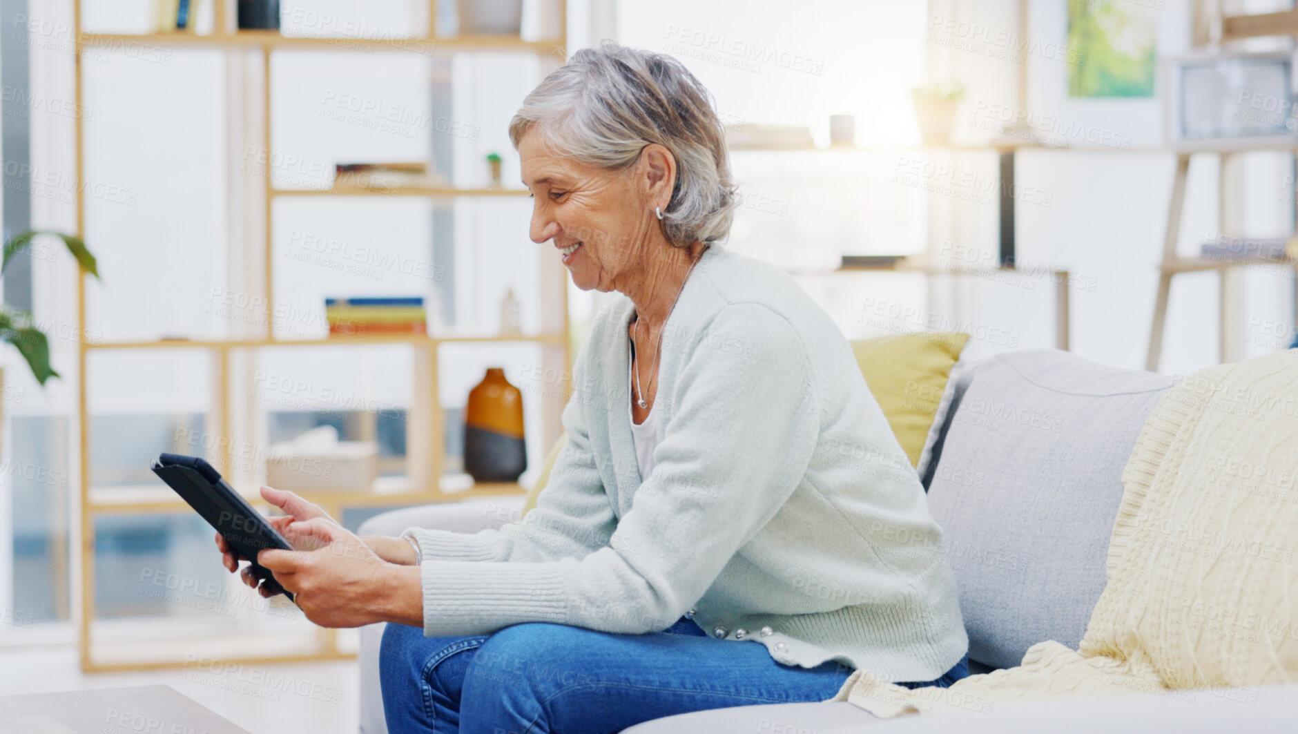 Buy stock photo Relax, tablet and senior woman on sofa in living room scroll on social media, mobile app or the internet. Rest, online and elderly female person browsing on website with technology in lounge at home.