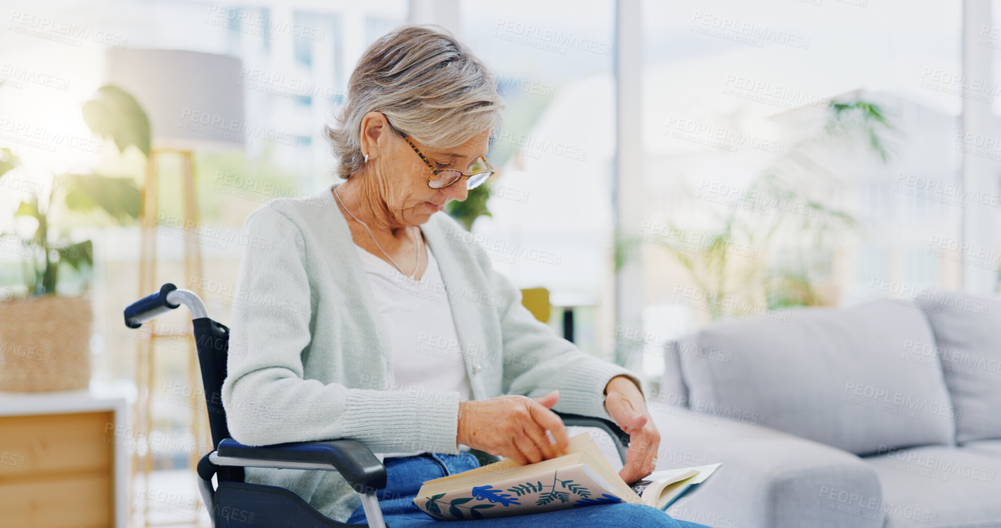 Buy stock photo Senior woman, book and reading to relax in living room for story, novel and knowledge. Elderly female in wheelchair, enjoying books and focus in lounge for retirement break, literature and hobby at retirement care