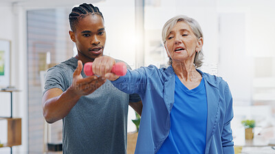 Senior woman, nurse and rehabilitation with dumbbells exercise in a nursing home for fitness. Elderly patient with a therapist man for healing, health and physiotherapy for arms, muscle and body