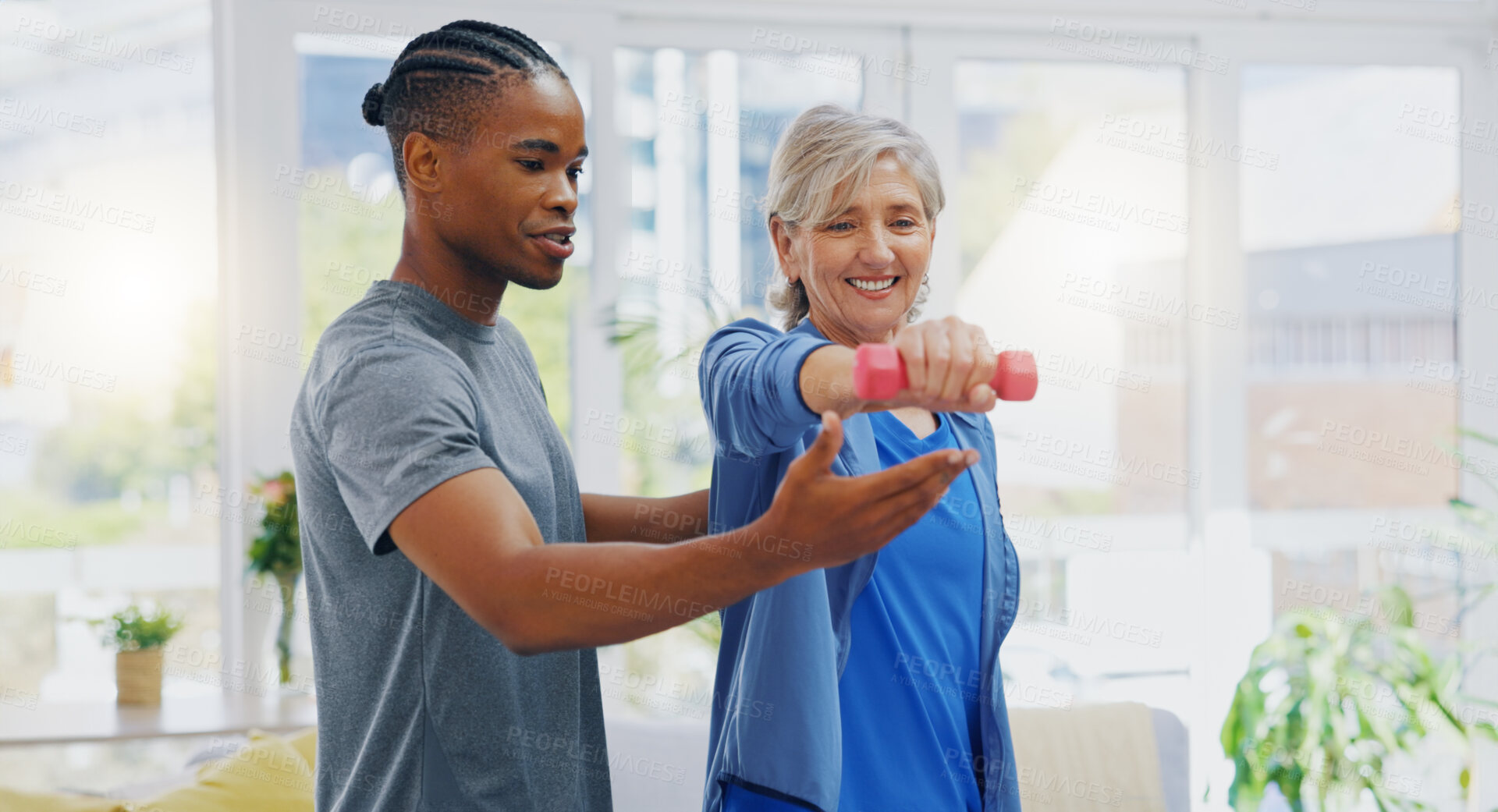 Buy stock photo Elderly woman, dumbbells and rehabilitation therapist for exercise in a nursing home. Happy senior patient with physiotherapist man or nurse for healing, health and physiotherapy for muscle and body