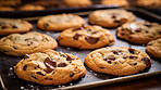 Chocolate chip cookies on a baking tray. Fresh homemade sweet snack.