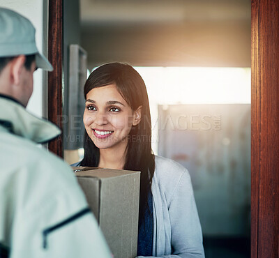 Buy stock photo Cropped shot of a young woman receiving her package from the courier
