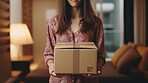 Young woman carrying large box during a move to new home or package delivery