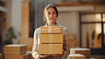 Young woman carrying large box during a move to new home or package delivery