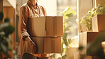 Young woman carrying large box during a move to new home or package delivery