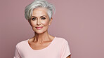 Radiant mature senior model woman with grey hair laughing and smiling for spa and dental