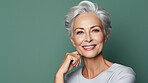 Radiant mature senior model woman with grey hair laughing and smiling for spa and dental