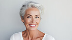 Radiant mature senior model woman with grey hair laughing and smiling for spa and dental