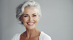 Radiant mature senior model woman with grey hair laughing and smiling for spa and dental