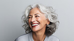 Radiant mature senior model woman with grey hair laughing and smiling for spa and dental