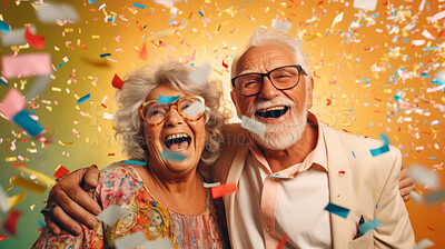 Happy senior couple celebrating birthday and in retirement with confetti and fun.