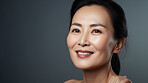 Radiant mature senior model woman smiling for spa beauty and skincare in studio