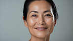 Radiant mature senior model woman smiling for spa beauty and skincare in studio