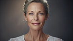 Radiant mature senior model woman smiling for spa beauty and skincare in studio