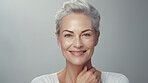 Radiant mature senior model woman smiling for spa beauty and skincare in studio