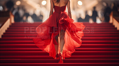 Woman in red dress on celebrity red carpet. Festive award ceremony event