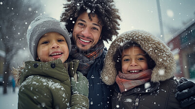 Portrait of African American family enjoying the winter snow during the Christmas season