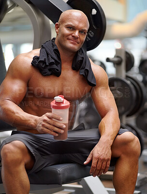 Buy stock photo Portrait of a male bodybuilder holding a protein shake while sitting on a weight bench at the gym