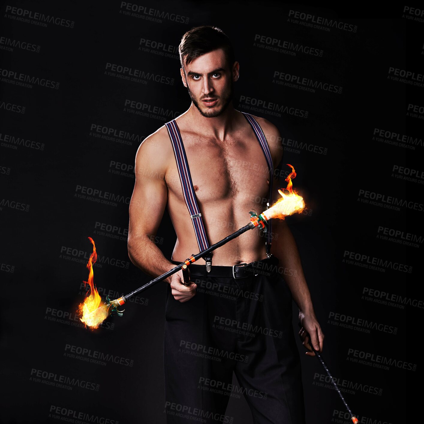 Buy stock photo Shot of a performer holding a flaming stick
