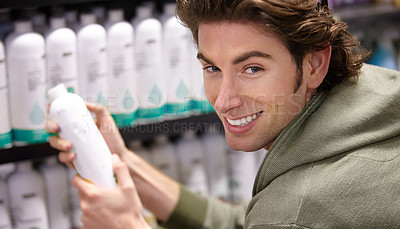 Buy stock photo Man, bottle and product shopping in grocery store or household supply, detergent or choice. Male person, smile and cosmetics for hygiene buy, supermarket shampoo deal or happy customer portrait 
