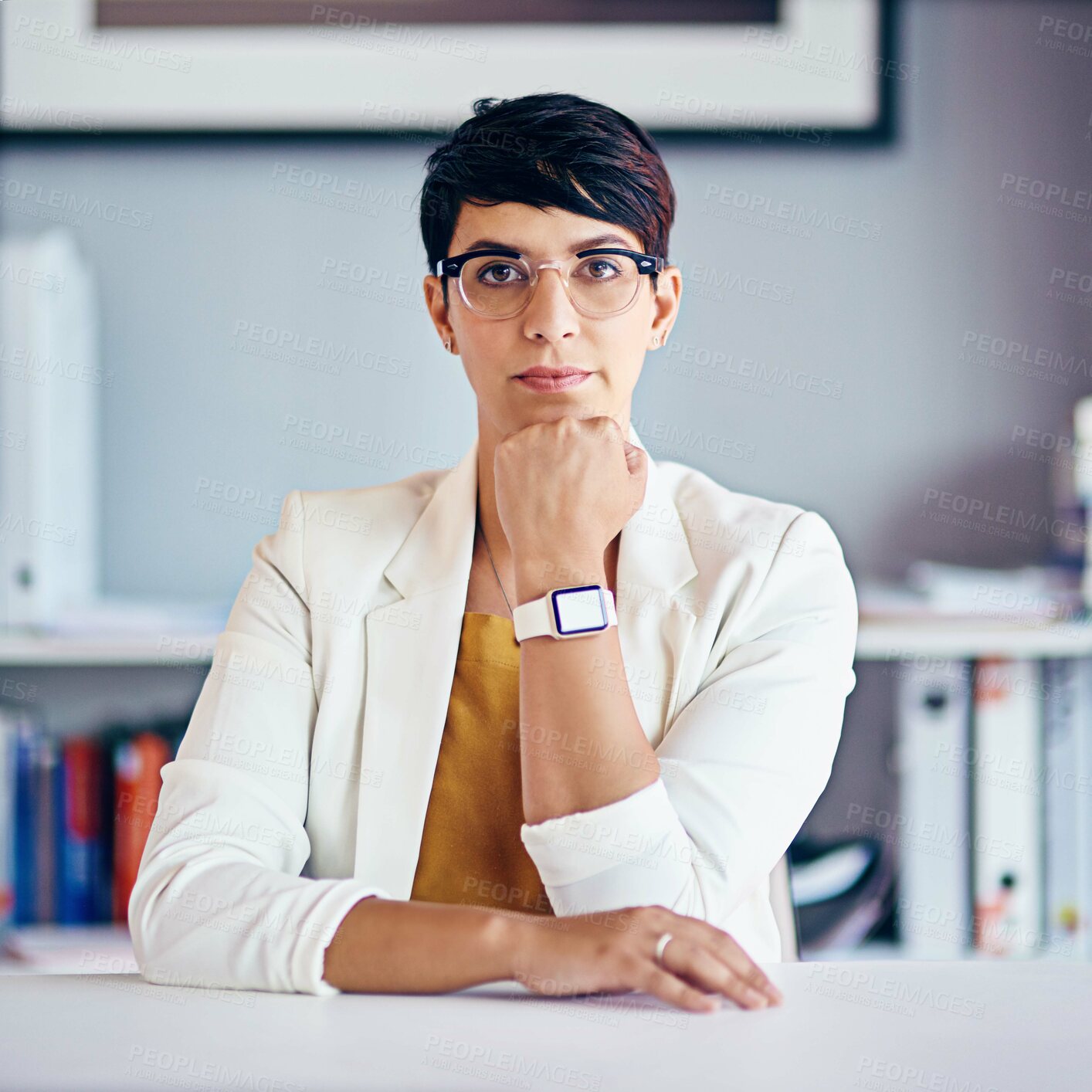 Buy stock photo Portrait of a young businesswoman sitting at her desk