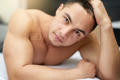 Buy stock photo Cropped shot of a handsome young man lying in bed