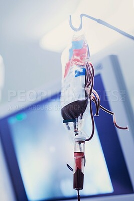 Buy stock photo Low angle shot of blood in an iv drip at a hospital