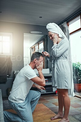 Buy stock photo Shot of a young couple looking happy after taking a pregnancy test at home