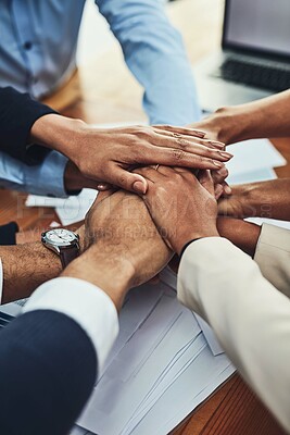 Buy stock photo Closeup shot of an unrecognizable group of businesspeople joining their hands together in a huddle in an office