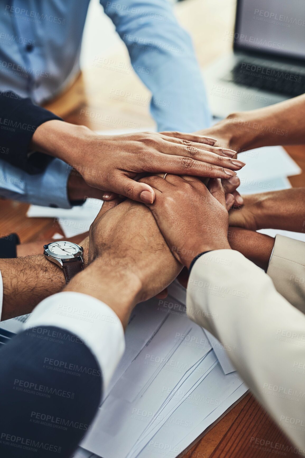 Buy stock photo Closeup shot of an unrecognizable group of businesspeople joining their hands together in a huddle in an office