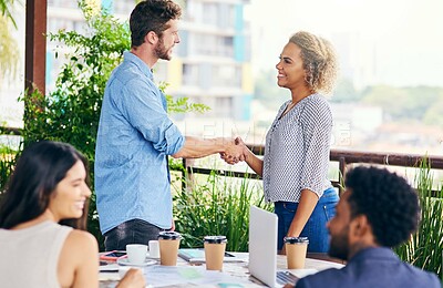 Buy stock photo Shot of businesspeople shaking hands during a meeting outdoors