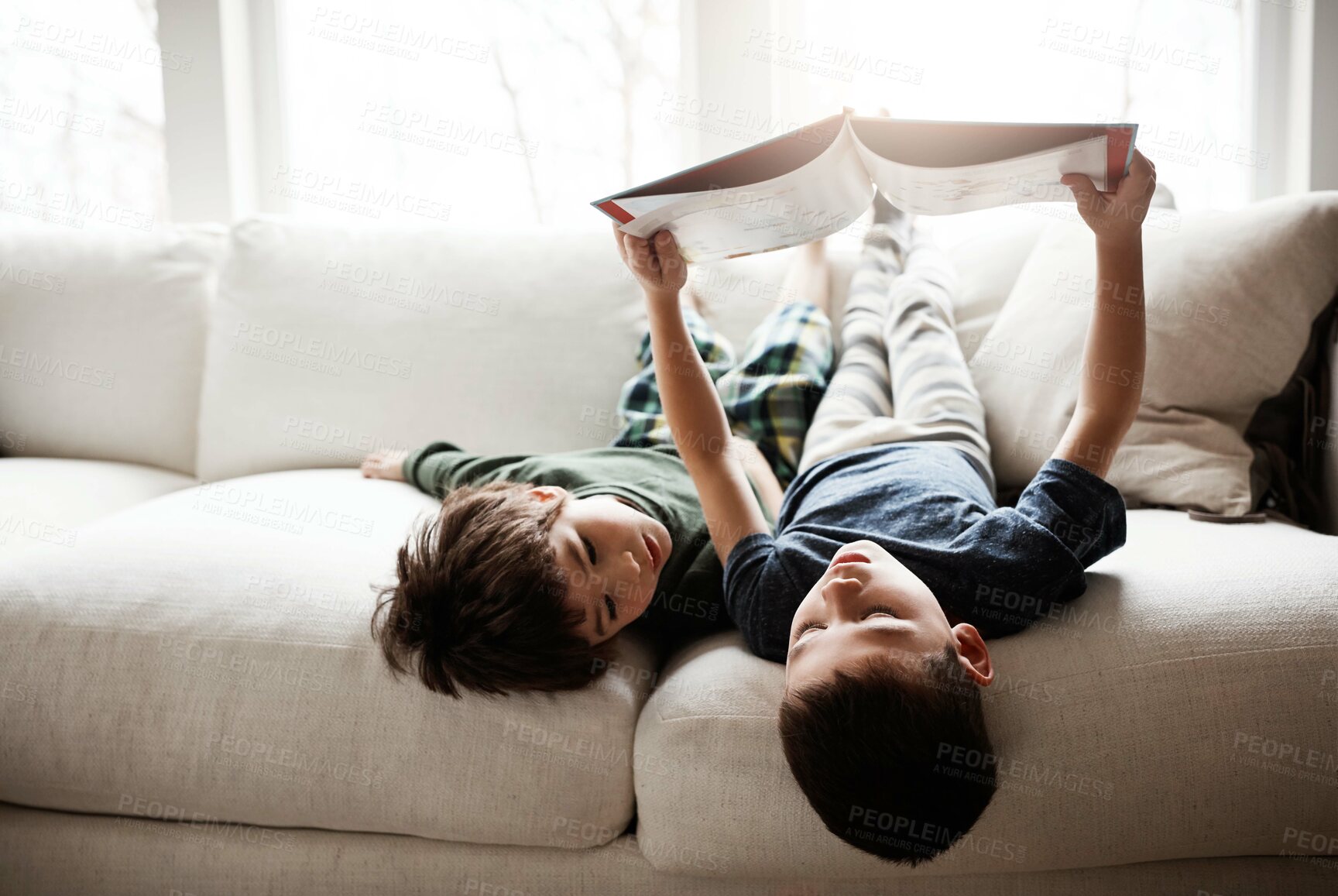 Buy stock photo Reading, learning and children with books on the sofa for knowledge, information and education. Relax, content and boys with a story for happiness, studying and playing on the living room couch