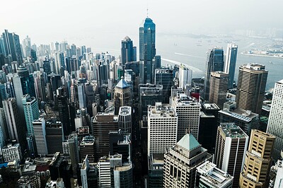 Buy stock photo Aerial shot of skyscrapers, office blocks and other commercial buildings in a busy coastal city