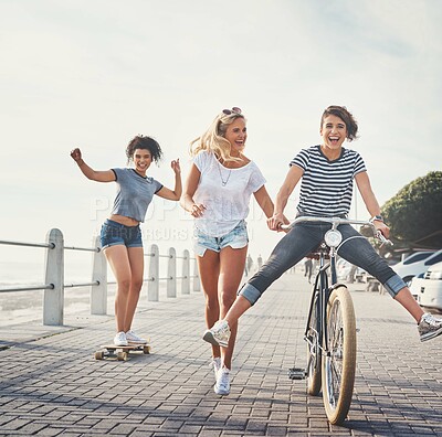 Buy stock photo Shot of three friends having fun on the promenade