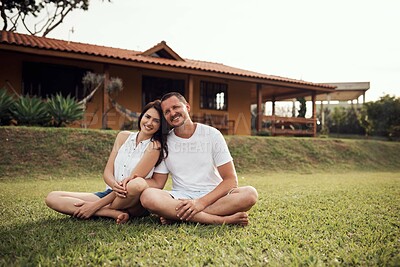 Buy stock photo Portrait of a couple sitting on the lawn outside their home