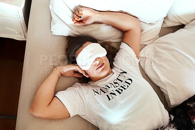 Buy stock photo Cropped shot of a young woman wearing a sleeping mask while sleeping in her bed at home