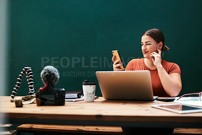 Buy stock photo Cropped shot of an attractive young businesswoman sitting alone at her desk and using her cellphone