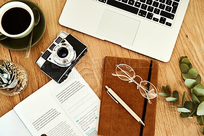 Buy stock photo High angle shot of technology and books on a blogger's work desk during the day