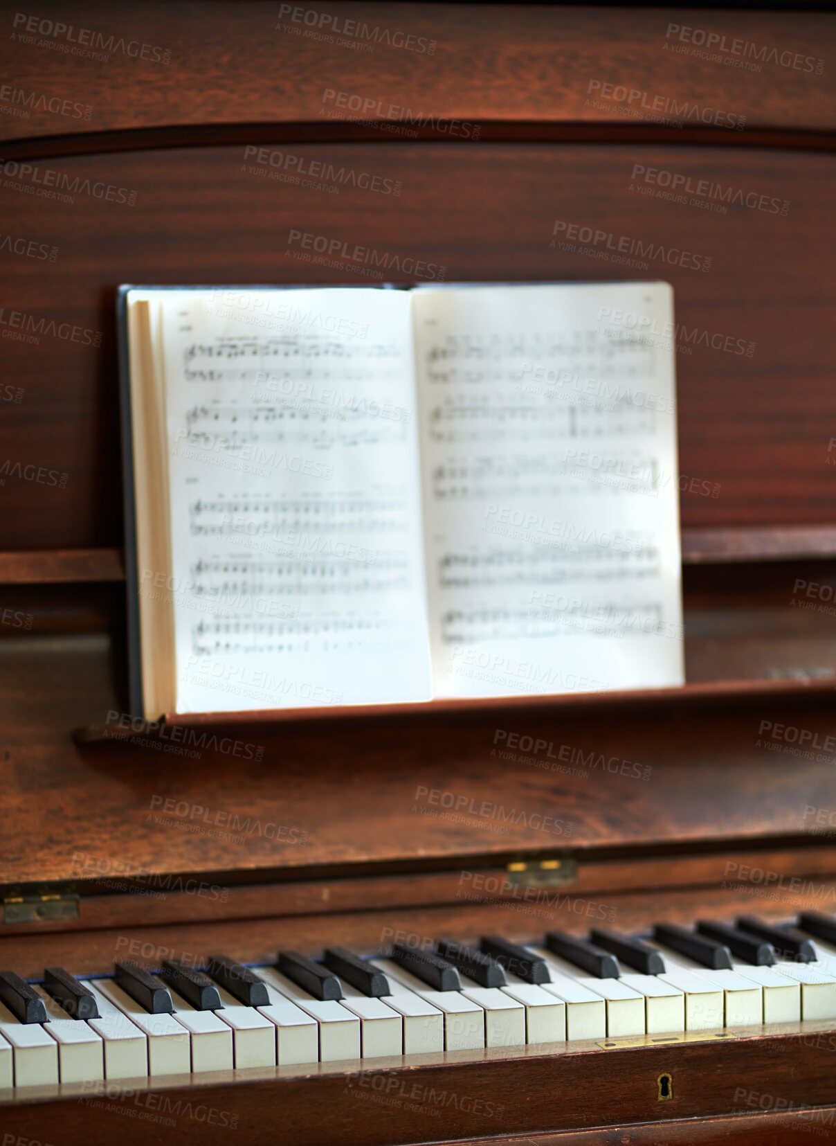 Buy stock photo Closeup of a vintage piano and keyboard with a sheet music book. An empty antique or wooden musical instrument for playing classical jazz or used for old traditional songwriting and rehearsals