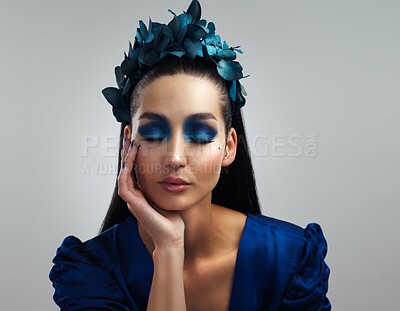 Buy stock photo Studio shot of a beautiful young woman posing with her eyes closed against a grey background